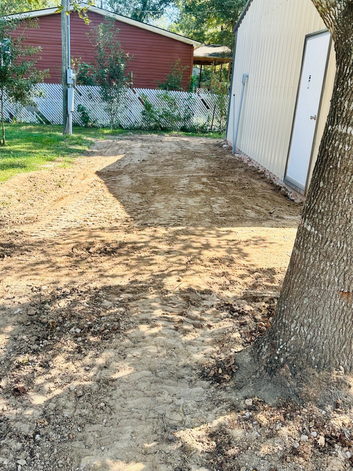 Regraded driveway between the shop and back fence