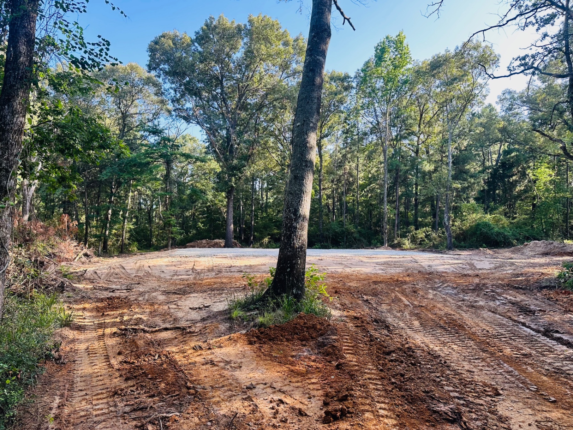 Completed gravel building pad in a wooded lot