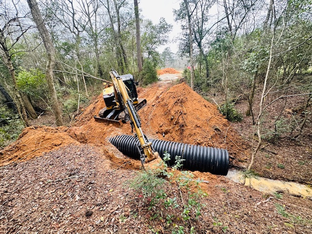 Installing a large HDPE culvert pipe in a fresh trench